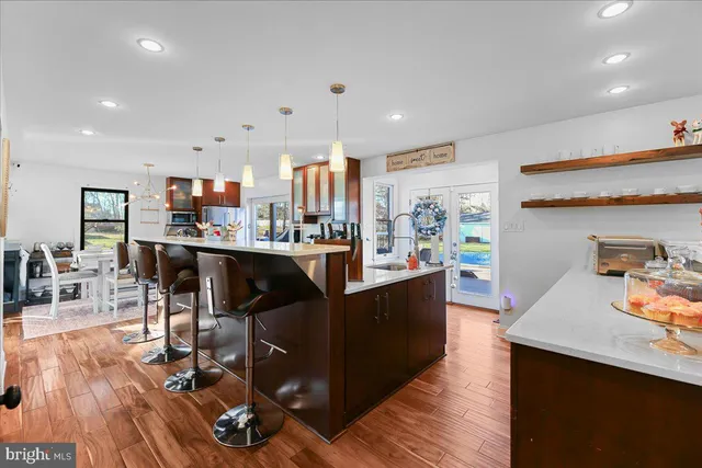 a living room with furniture potted plant and a large window