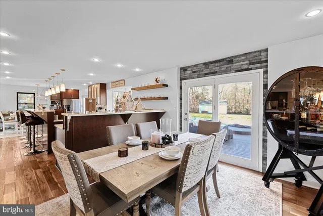 a view of a a dining room with furniture window and wooden floor