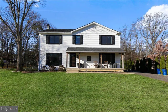 a view of a house with a yard and sitting area
