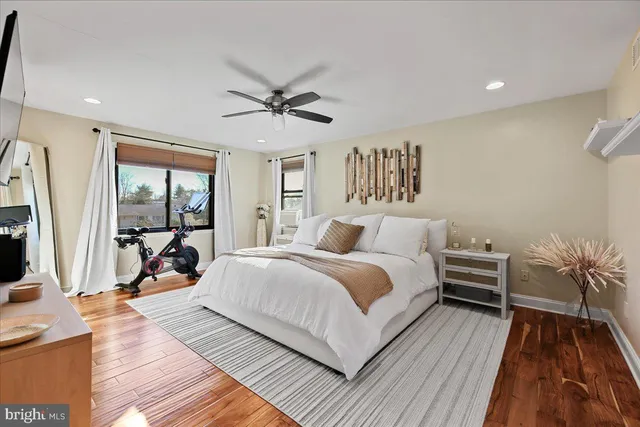 a bedroom with a bed and a large window