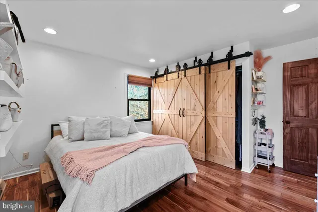 a bedroom with furniture and a large window