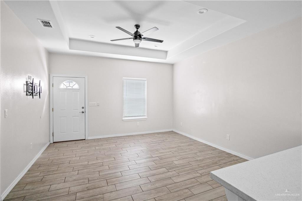 1511 Playa Drive, Unit 2 Weslaco, TX 78596 - Photo 13 of 28 wooden floor in an empty room with a window