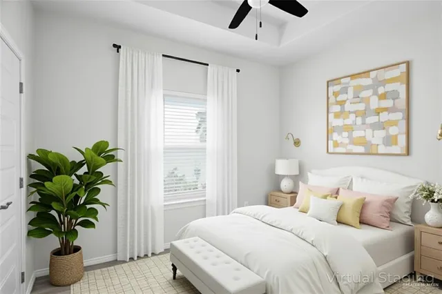 a bedroom with a large bed and a potted plant
