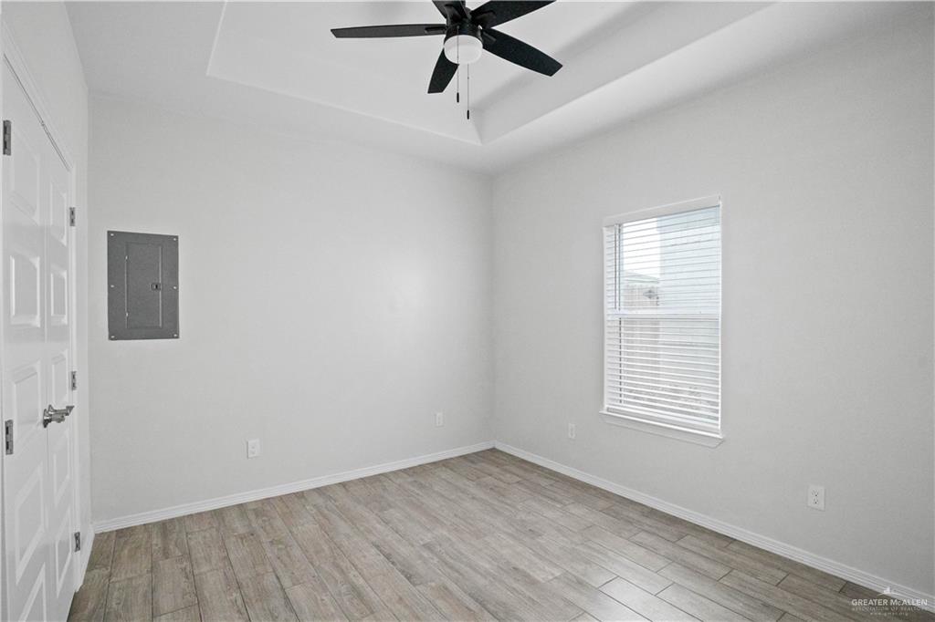 1511 Playa Drive, Unit 2 Weslaco, TX 78596 - Photo 19 of 28 wooden floor in an empty room with a window