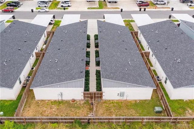 an aerial view of a house with a yard