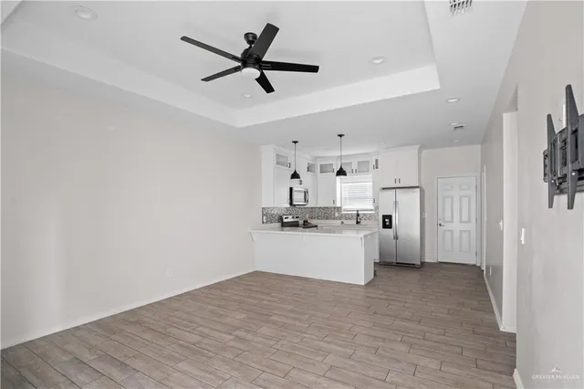 a kitchen with kitchen island white cabinets and stainless steel appliances