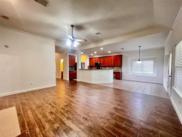 a view of a kitchen with a sink and a refrigerator