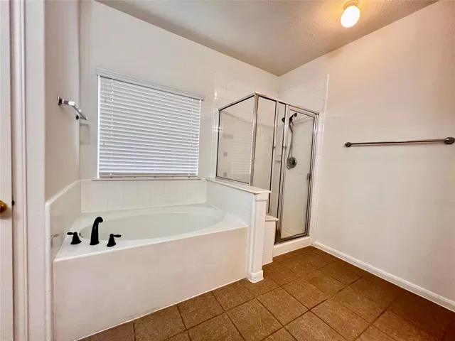 a bathroom with a bathtub and a shower