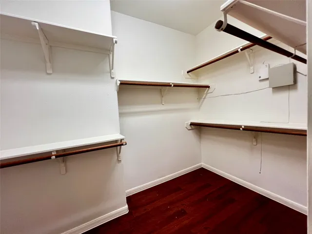 a view of a room with wooden floor