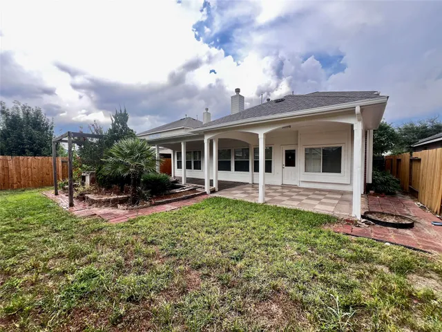 a view of a house with sitting area and garden