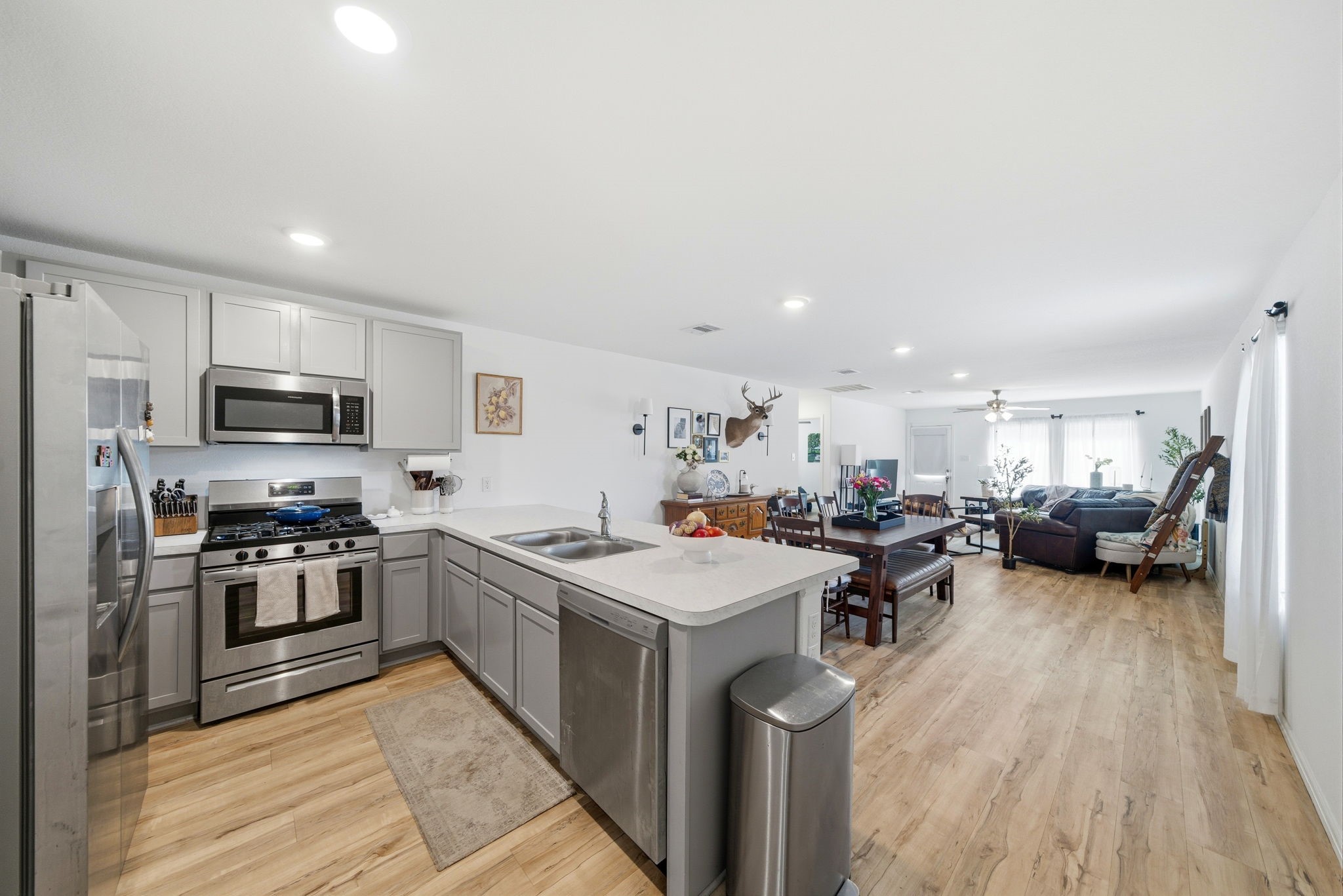 14502 Woodcott Warren Way Rosharon, TX 77583 - Photo 16 of 37 Open and inviting, this kitchen connects seamlessly to the dining and living areas, creating a natural space for gathering and entertaining