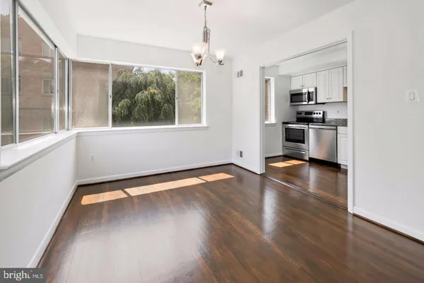 a kitchen with stainless steel appliances a stove top oven and a refrigerator