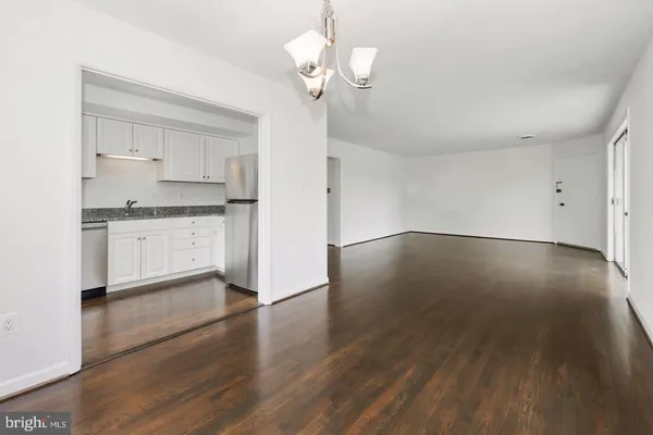a view of a kitchen with a sink and wooden floor