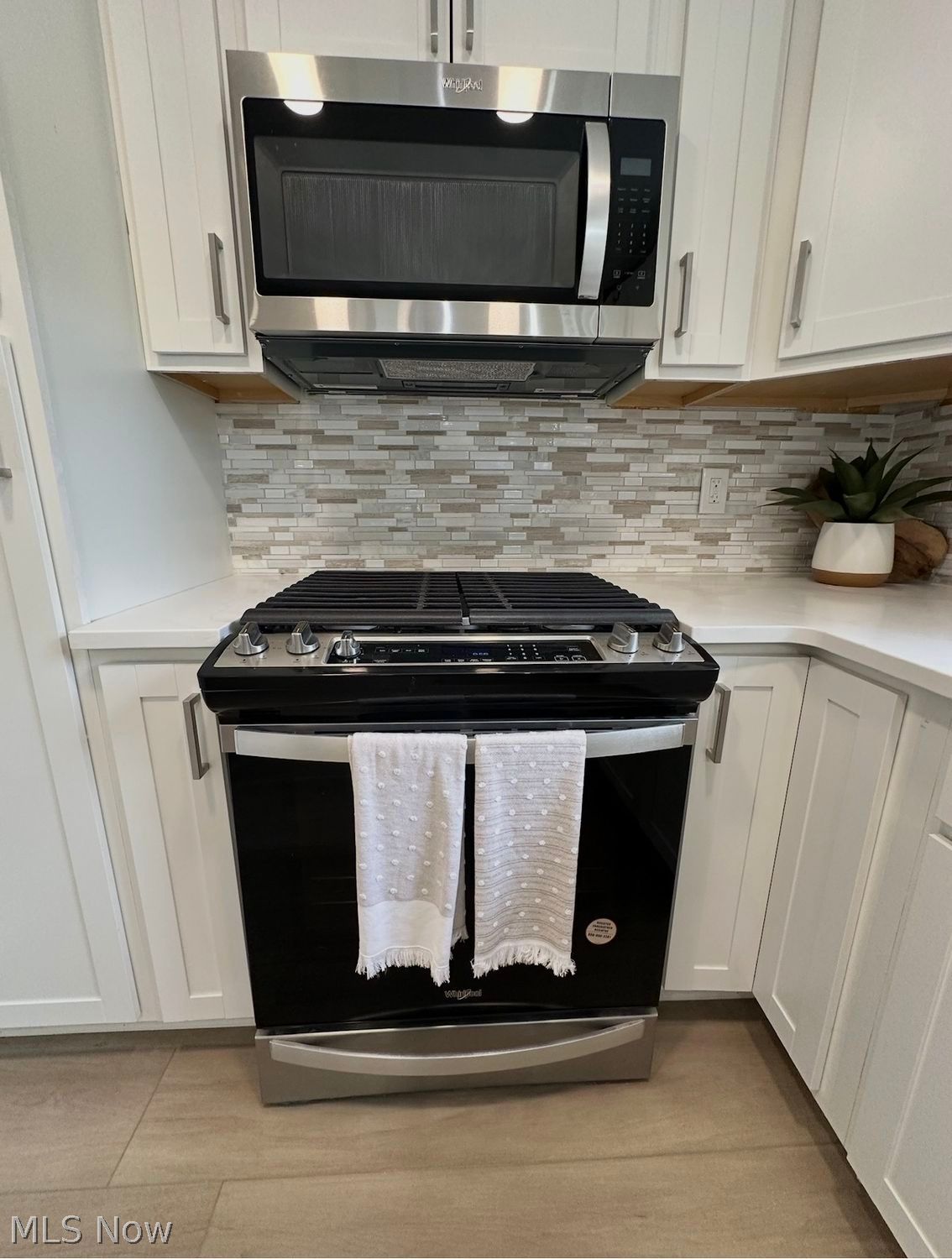 5366 Barton Road North Ridgeville, OH 44039 - Photo 22 of 49 Kitchen with brand new appliances, quartz countertops, recessed lighting, new cabinetry , stone mosaic backsplash and more.