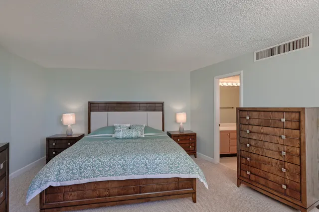 a bedroom with a bed and dresser