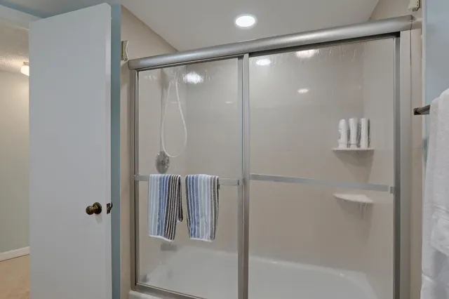 a bedroom with two beds and dresser