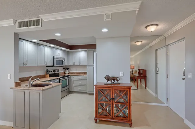 a kitchen with refrigerator and cabinets