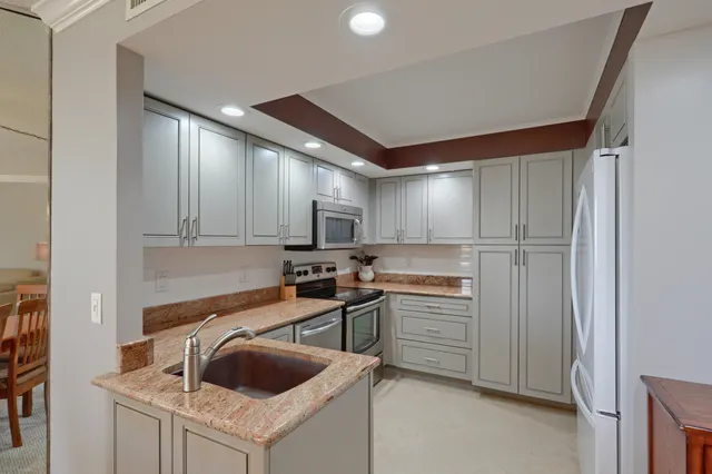 an aerial view of a house with garden space and swimming pool