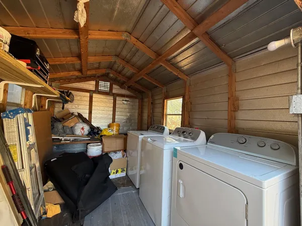 a view of storage and utility room with washer and dryer