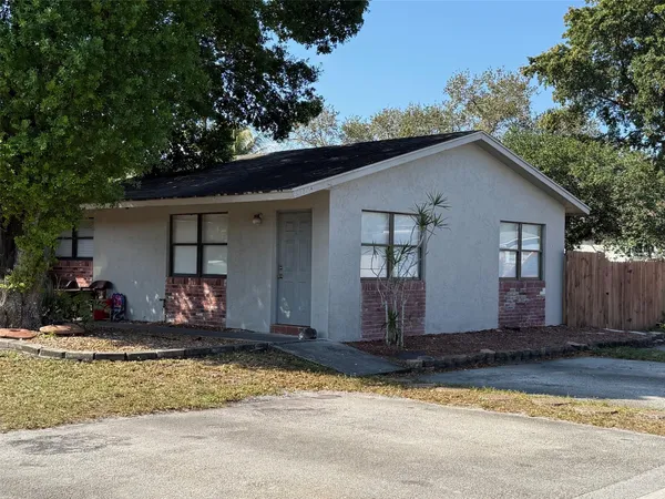 a view of house with street next to a yard