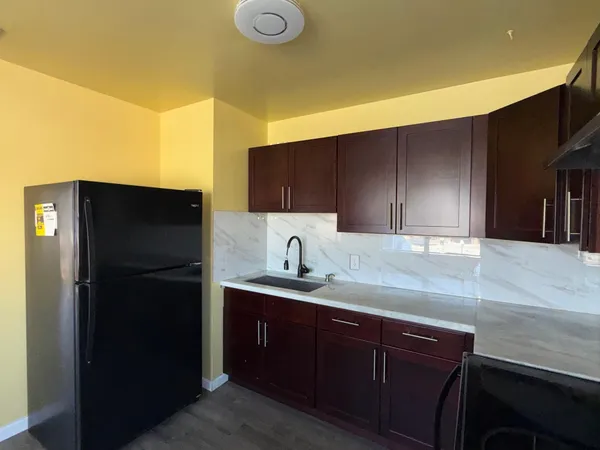 a kitchen with a sink and a refrigerator
