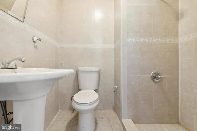 a white toilet sitting next to a bathroom sink