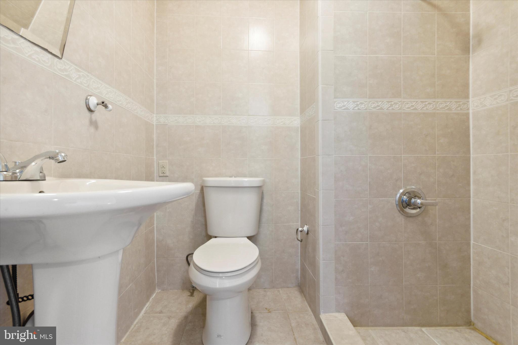 417 Garfield Avenue, Unit 2 Folcroft, PA 19032 - Photo 11 of 14 a bathroom with a toilet sink and shower