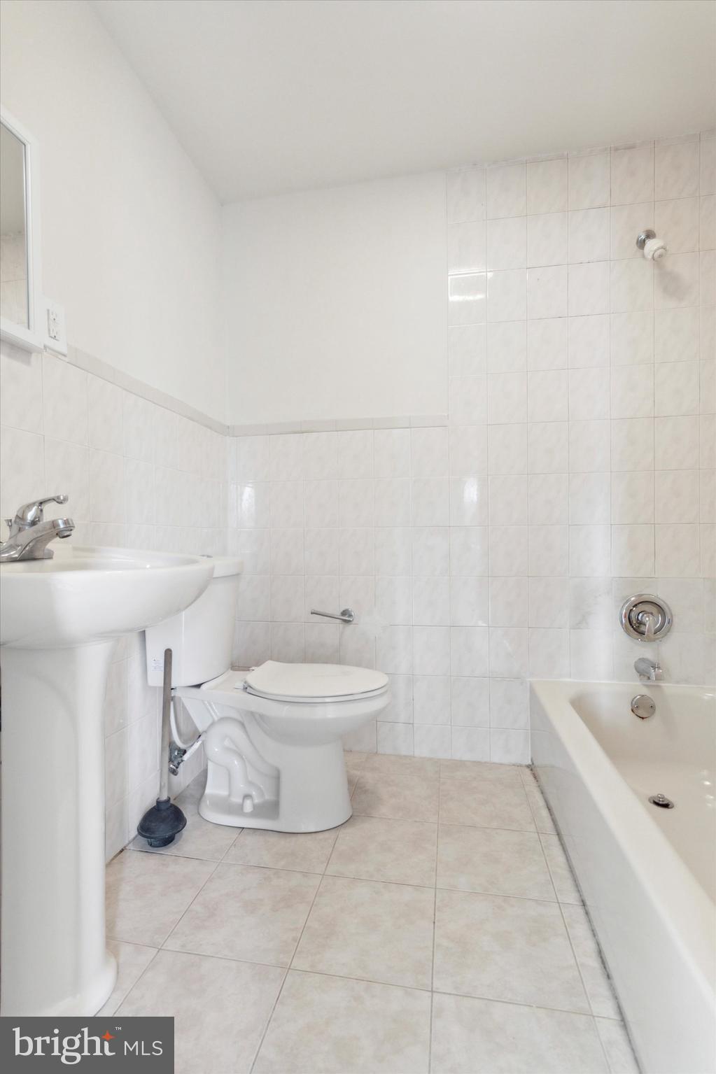 417 Garfield Avenue, Unit 2 Folcroft, PA 19032 - Photo 12 of 14 a white toilet sitting next to a bathroom sink