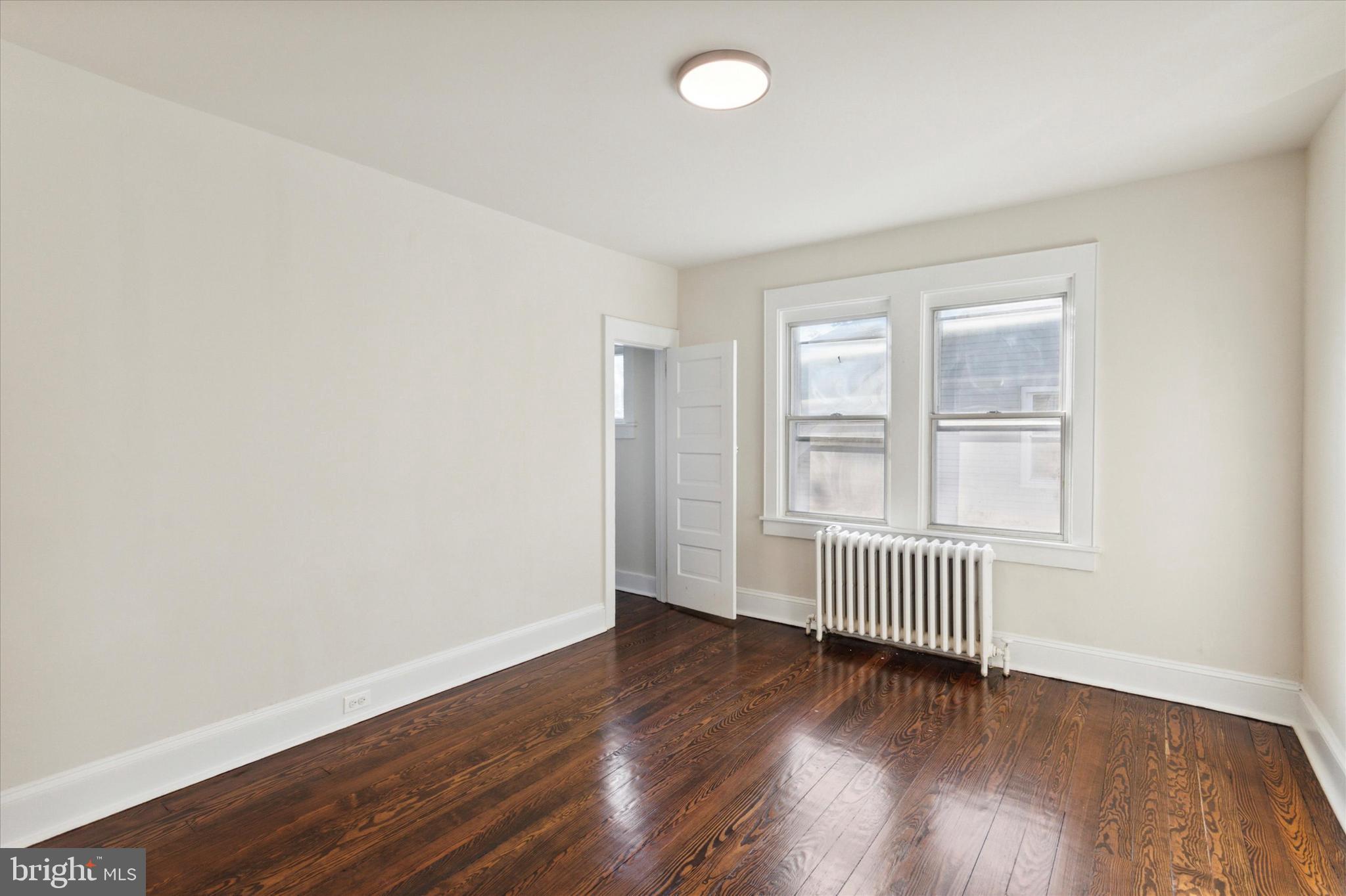 417 Garfield Avenue, Unit 2 Folcroft, PA 19032 - Photo 2 of 14 an empty room with wooden floor and windows