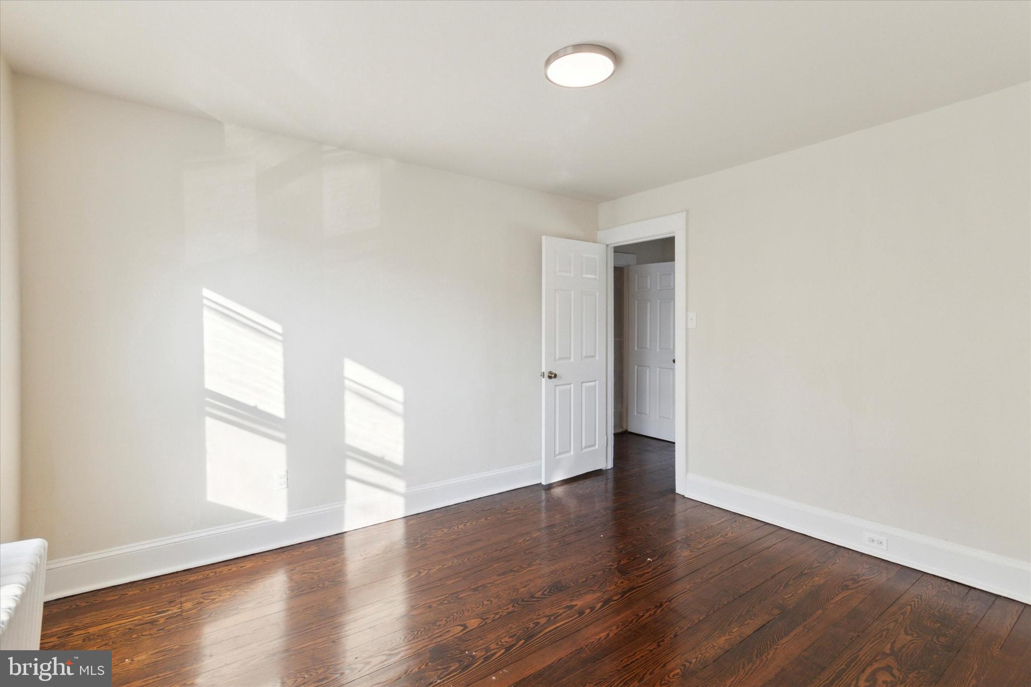 417 Garfield Avenue, Unit 2 Folcroft, PA 19032 - Photo 3 of 14 an empty room with wooden floor and windows