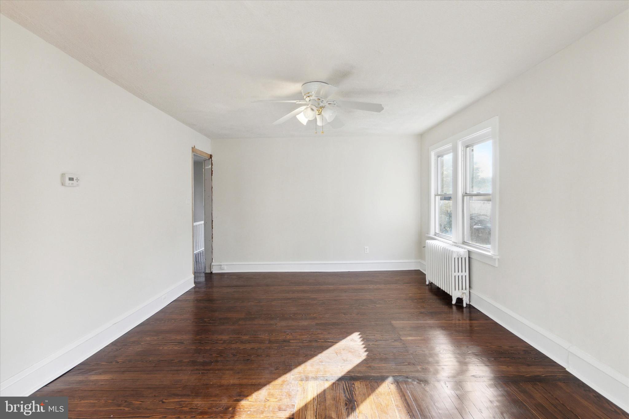 417 Garfield Avenue, Unit 2 Folcroft, PA 19032 - Photo 8 of 14 an empty room with wooden floor fan and windows