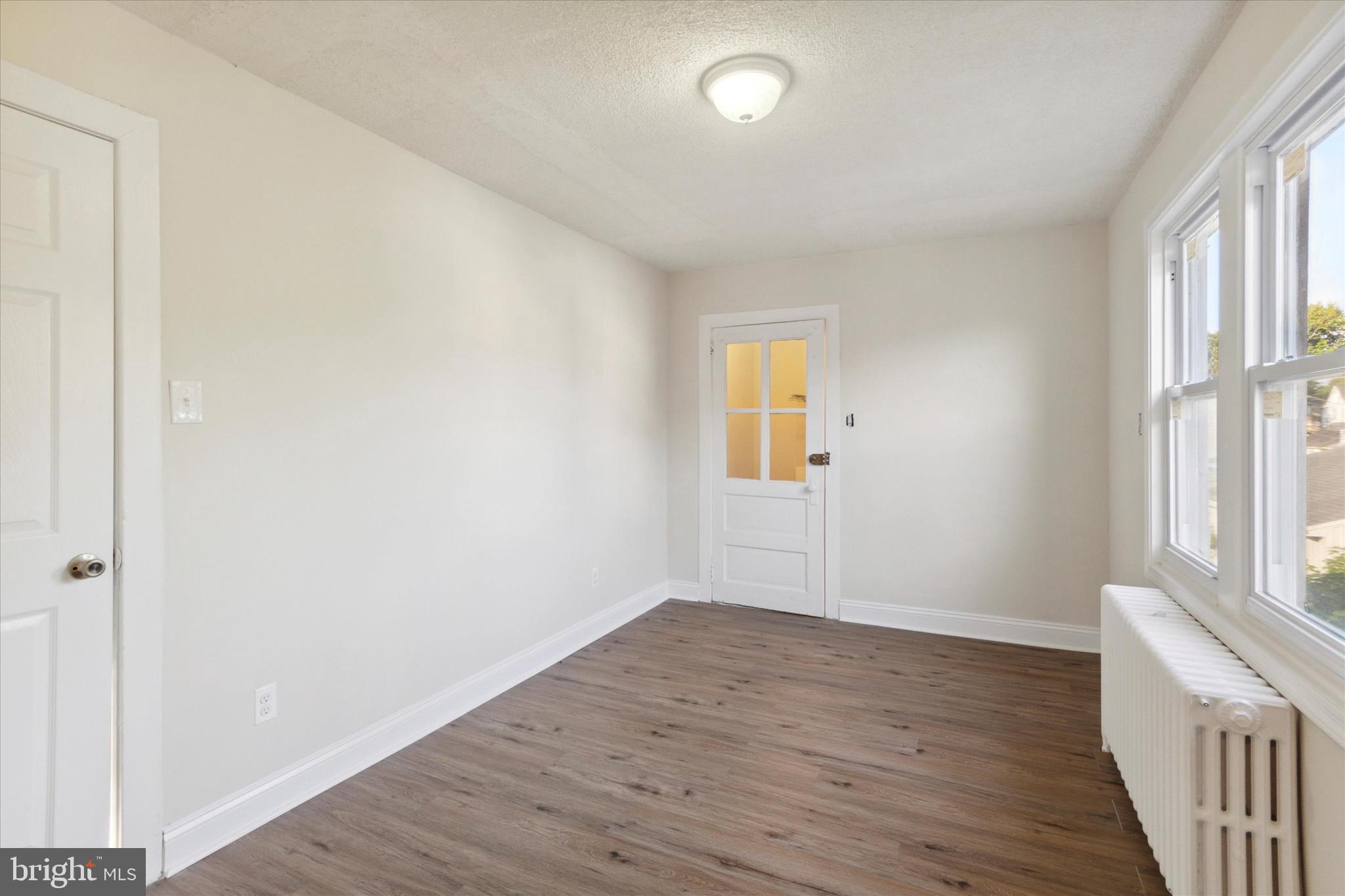 417 Garfield Avenue, Unit 2 Folcroft, PA 19032 - Photo 10 of 14 an empty room with wooden floor and windows
