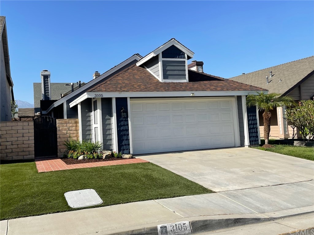 3105 Antler Road Ontario, CA 91761 - Photo 1 of 1 a front view of a house with a garden and plants