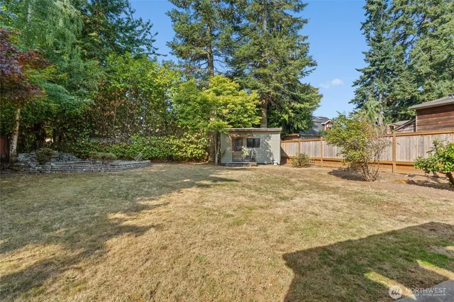 a backyard of a house with table and chairs