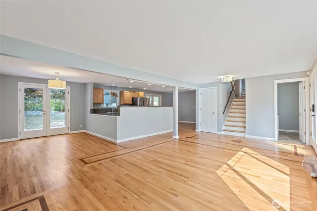 a view of a livingroom with wooden floor and stairs