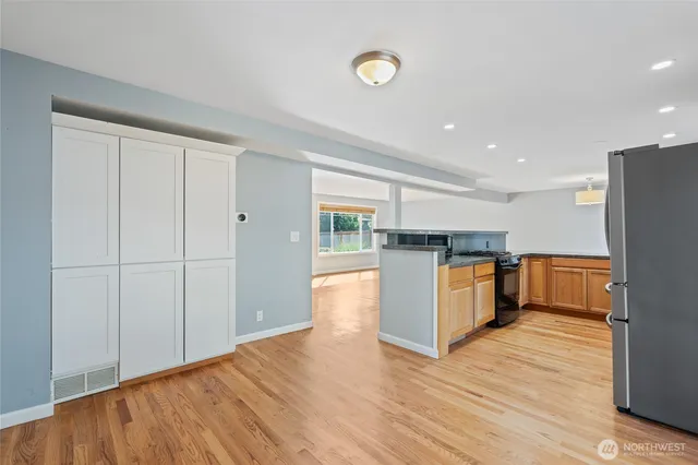 a kitchen with stainless steel appliances granite countertop a refrigerator and a stove top oven