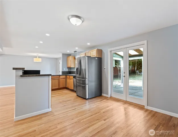 a kitchen with refrigerator and microwave