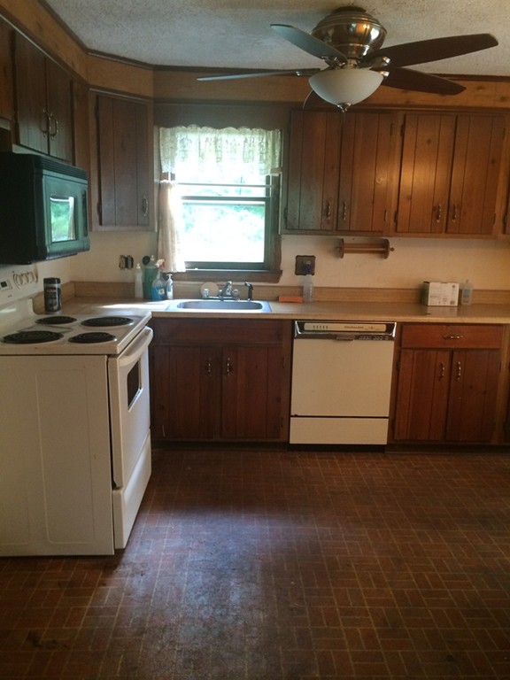 277 Fowler Road Northbridge, MA 01534 - Photo 4 of 14 a kitchen with a sink stove and cabinets