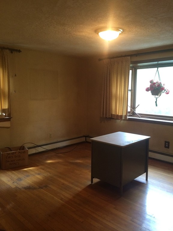 277 Fowler Road Northbridge, MA 01534 - Photo 5 of 14 an empty room with wooden floor and windows