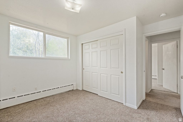 149 West 1600th Street South Mapleton, UT 84664 - Photo 21 of 44 Unfurnished bedroom with light carpet, baseboard heating, and a closet