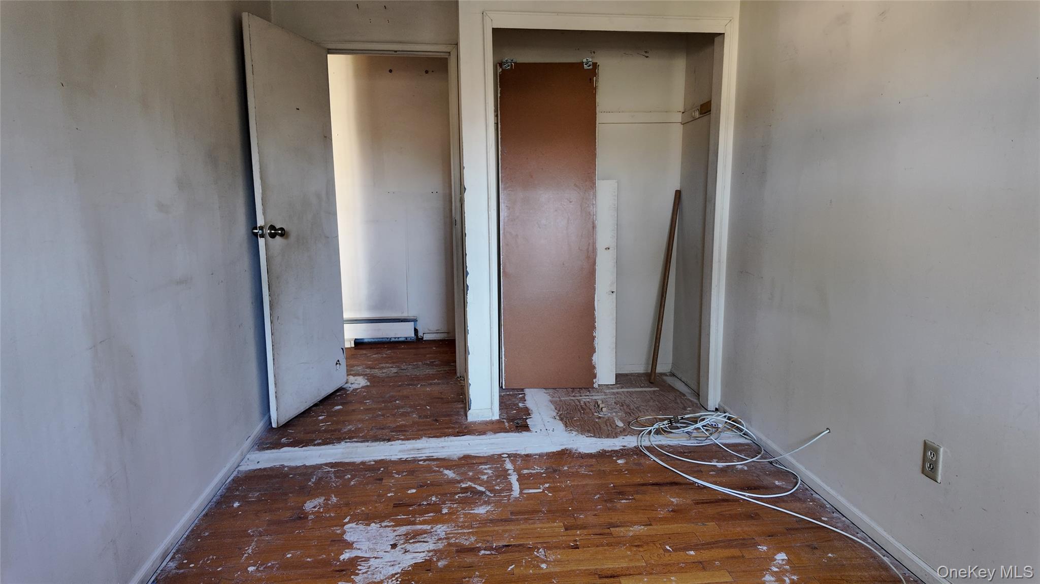 80 Sneden Place, Unit 80 Spring Valley, NY 10977 - Photo 4 of 5 a view of a bedroom with wooden floor and a bathroom