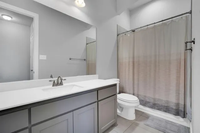 a bedroom with a bed table and window