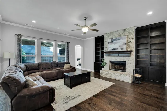 a living room with furniture wooden floor and a table