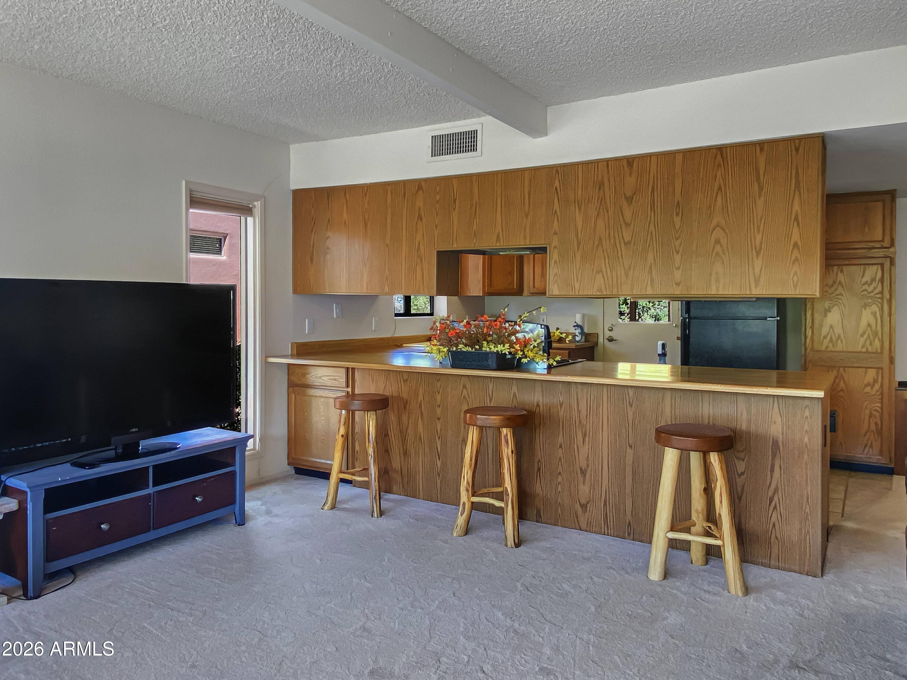 550 Barcelona Road Sedona, AZ 86336 - Photo 9 of 32 a living room with furniture and a flat screen tv