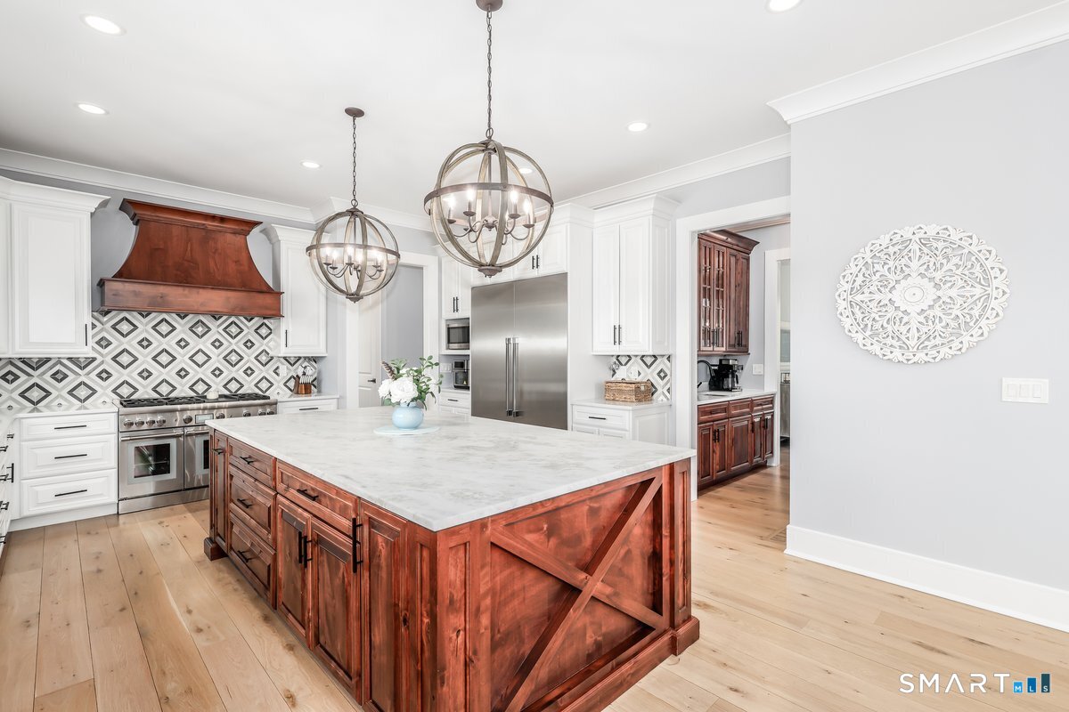 2 Pond View Lane Sherman, CT 06784 - Photo 12 of 40 a kitchen with stainless steel appliances granite countertop a stove a sink dishwasher and a dining table with wooden floor