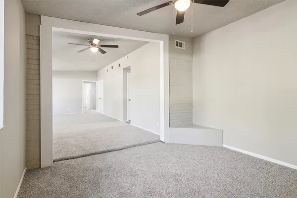 a view of a dining room with furniture and a chandelier