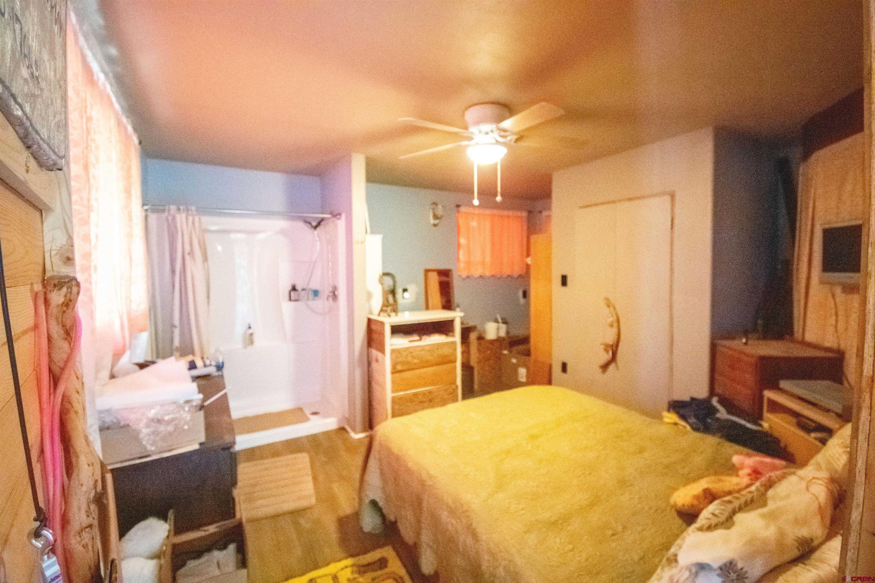 3743 1600th Road Delta, CO 81416 - Photo 22 of 22 a bedroom with a bed and wooden floor