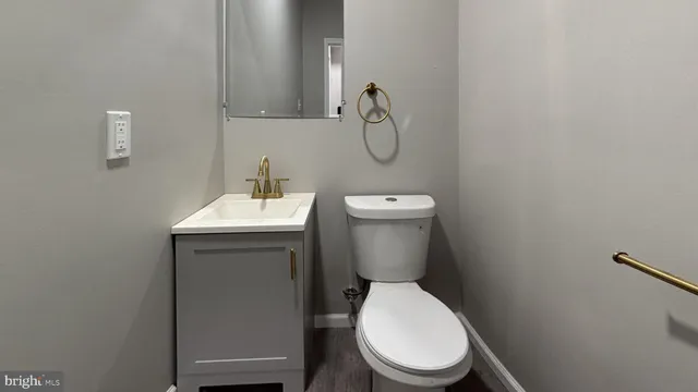 a white toilet sitting next to a bathroom sink