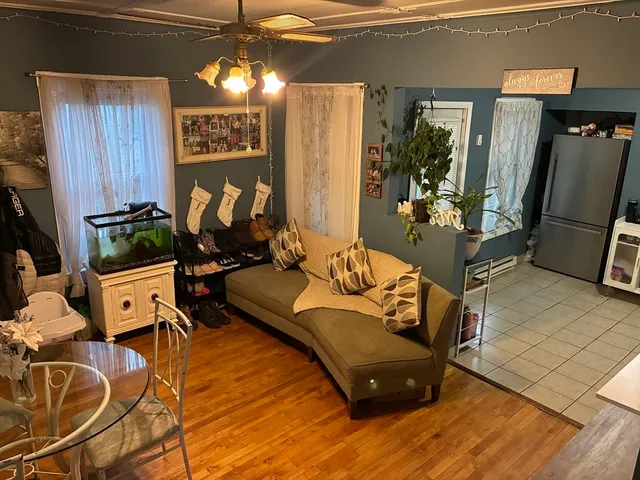 a living room with furniture window and a flat screen tv