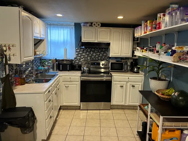 a kitchen with a sink stove and cabinets